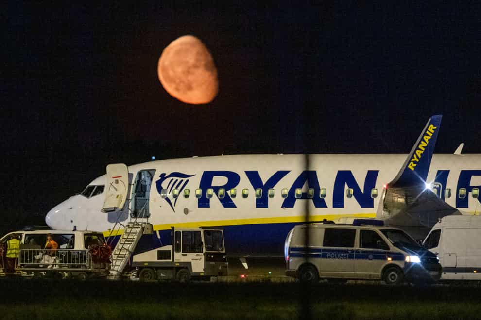 Federal police inspect a Ryanair aircraft after the unscheduled landing of the plane at the Berlin International Airport in Schoenefeld near Berlin, Germany