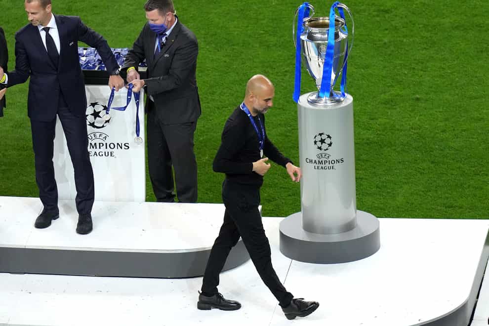 Manchester City boss Pep Guardiola walks past the European Cup after his side were beaten 1-0 by Chelsea in Porto (Adam Davy/PA).