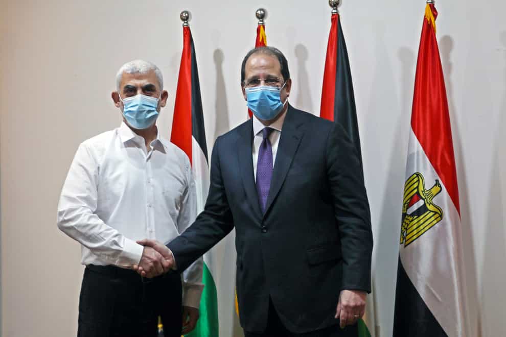 Yehiyeh Sinwar, left, the top Hamas leader in Gaza, and the head of the Egyptian General Intelligence Abbas Kamel