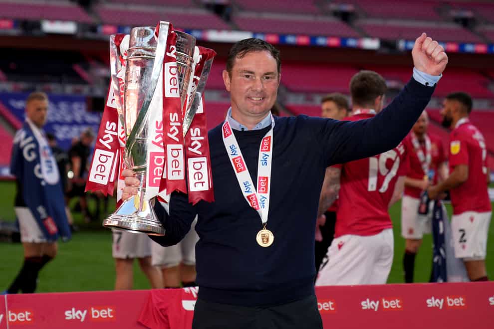 Morecambe manager Derek Adams refused to commit his future to the club after they reached the third tier of English Football for the first time in their history