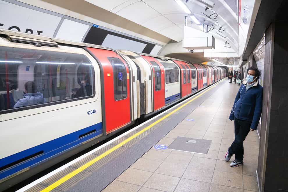 A passenger waits to board a London Underground train