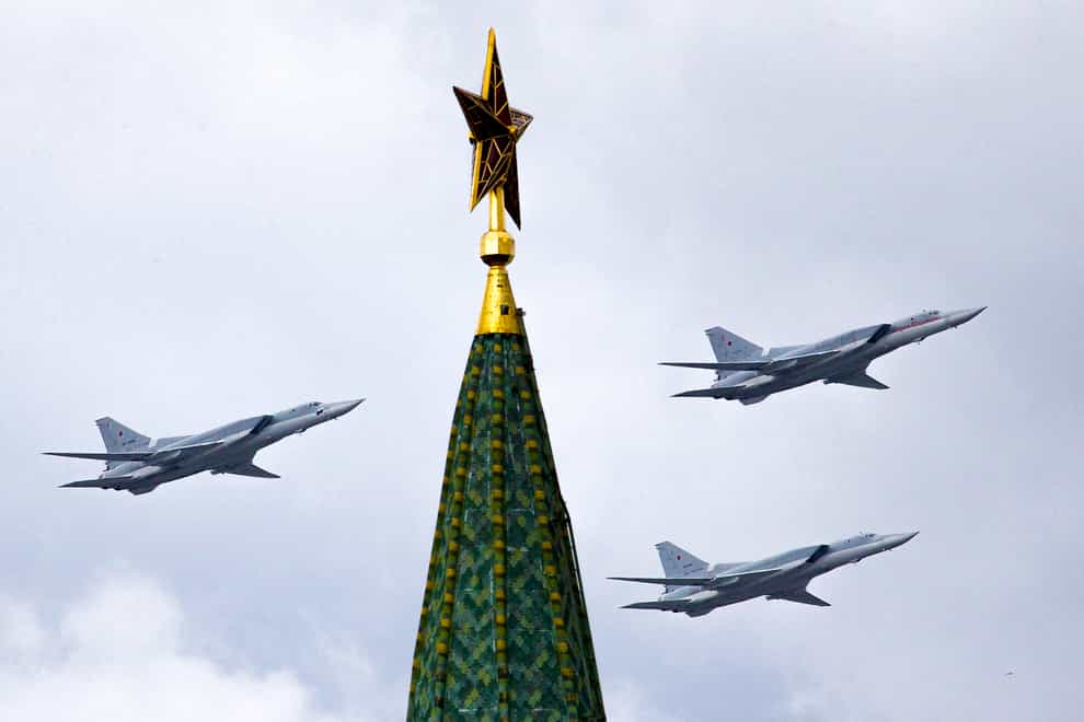 Russian Tu-22M3 bombers fly over the Kremlin’s Tower with a Red Star on the top (Ivan Sektretarev/AP)