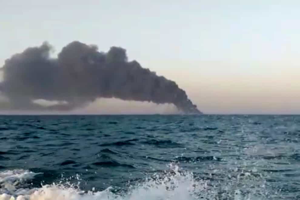 Smoke rising from Iran’s navy support ship Kharg in the Gulf of Oman (AP)