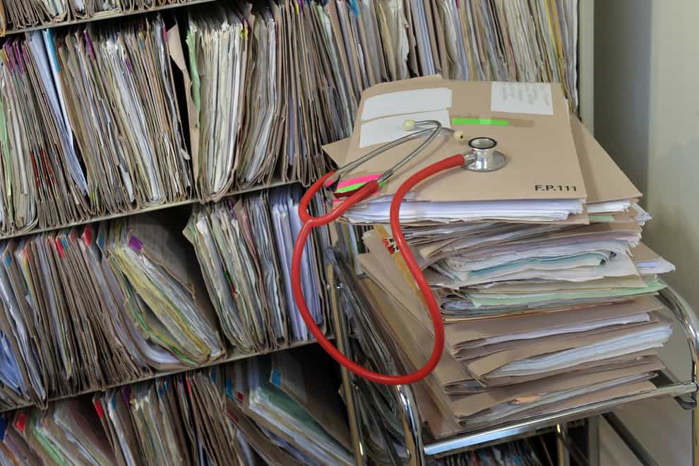 A stethoscope on top of patient’s files at a GP surgery