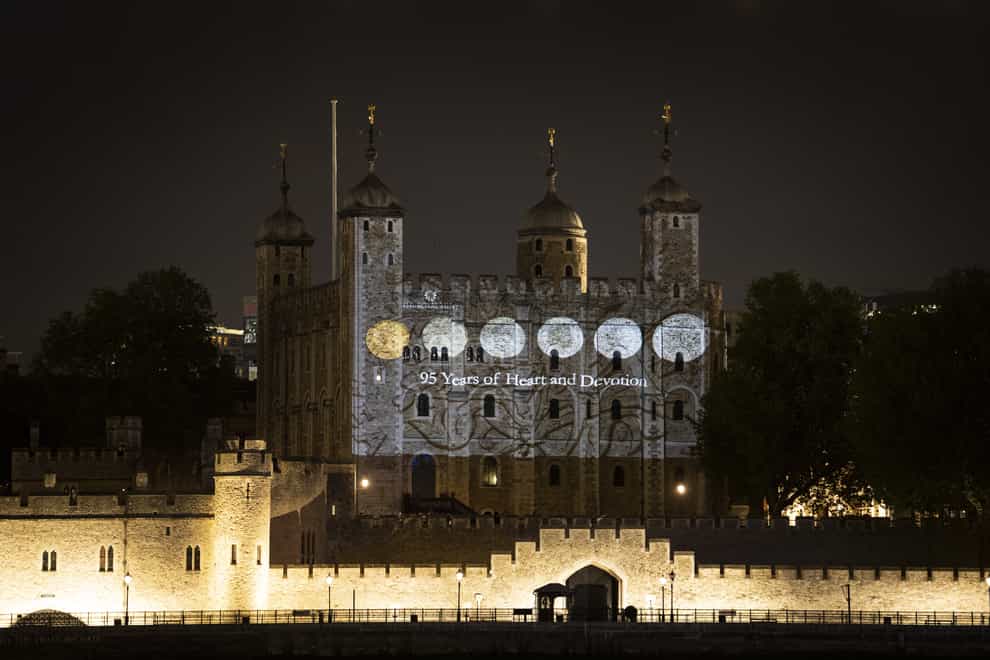 The south wall of the Tower of London bearing projected images of coins from the Queen's reign