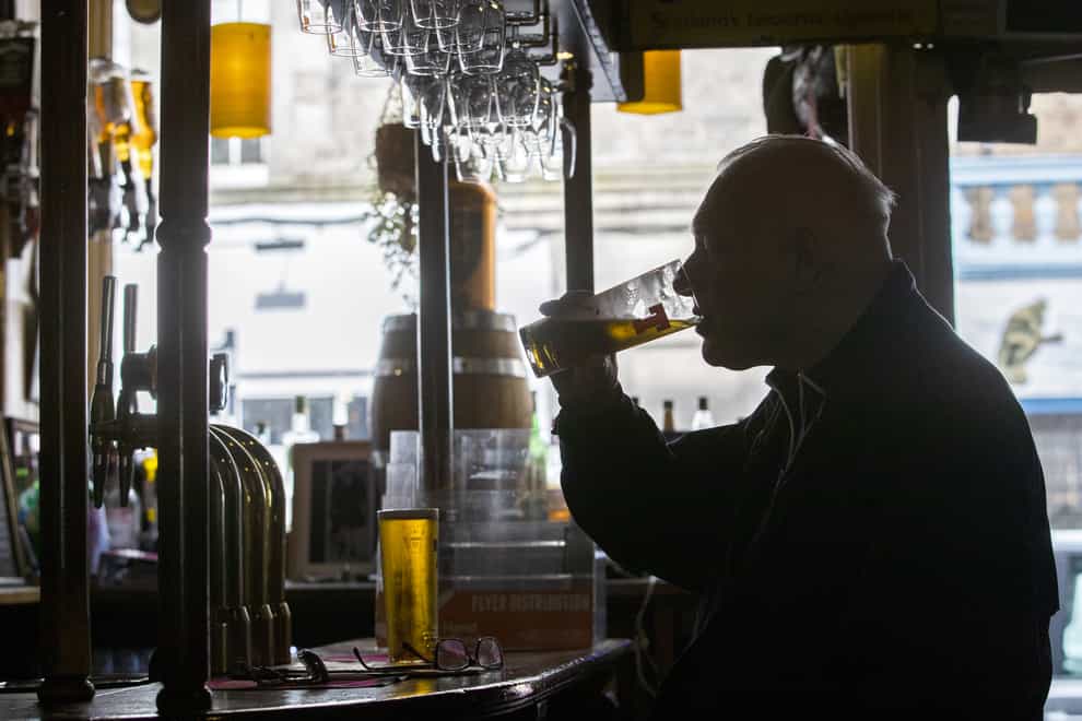 A man drinking in a public house (Jane Barlow/PA)