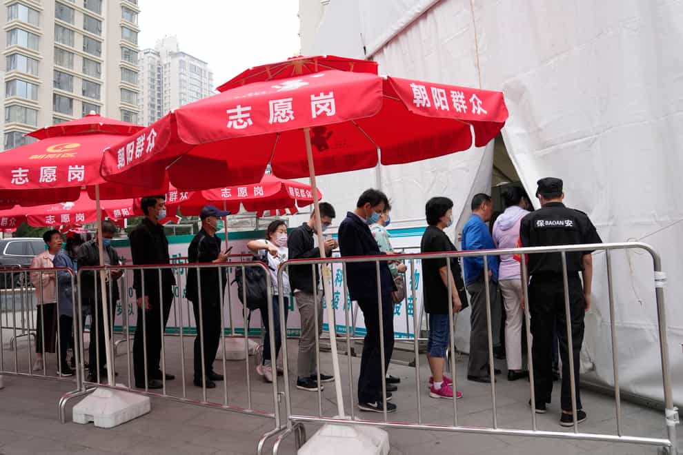 Residents line up outside a vaccination centre in Beijing