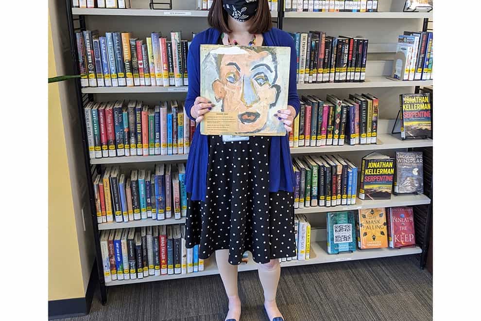 Sara Phillips, a branch manager at Heights Libraries in Ohio, holds the Bob Dylan album