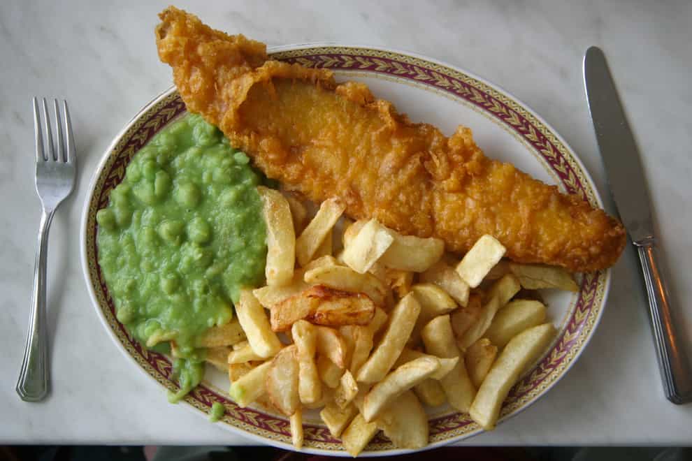 Fish and chips and mushy peas on a plate