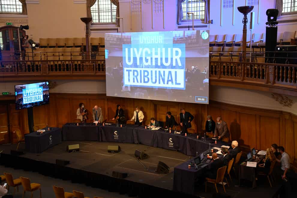 Members of the independent tribunal take their seats for the first session of the hearings at Church House, in London