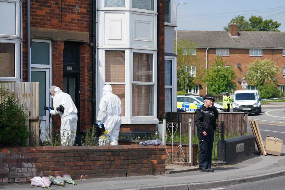 Police and forensic officers at the scene in High Holme Road, Louth
