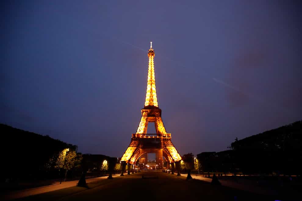The Eiffel Tower is illuminated in Paris