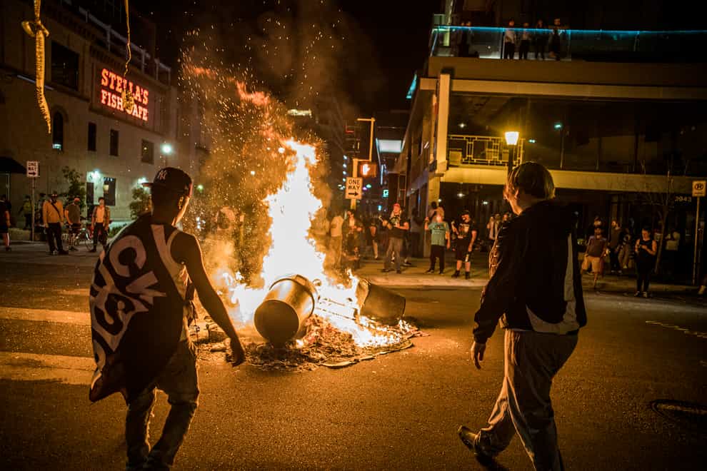 Protesters set a fire after the shooting