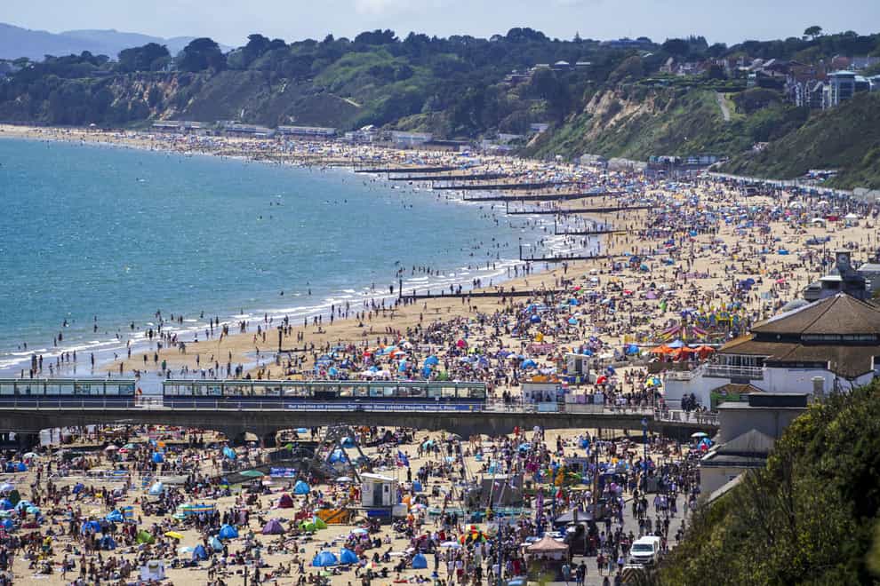 People enjoy the weather on Bournemouth beach in Dorset