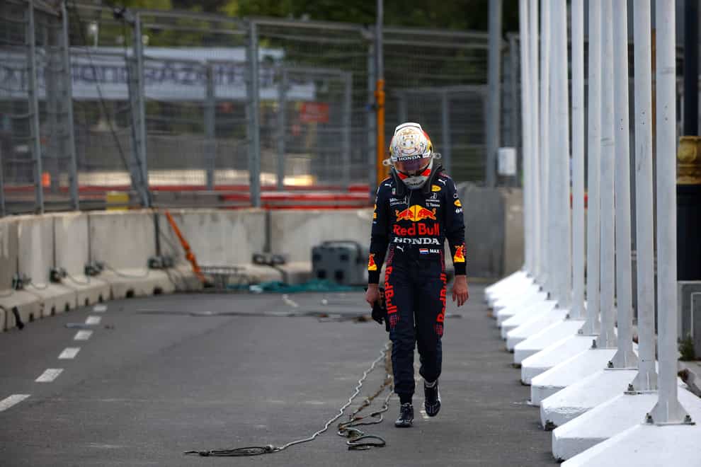 Red Bull's Max Verstappen walks off the track after crashing out five laps from the end of the Azerbaijan Grand Prix following a tyre failure