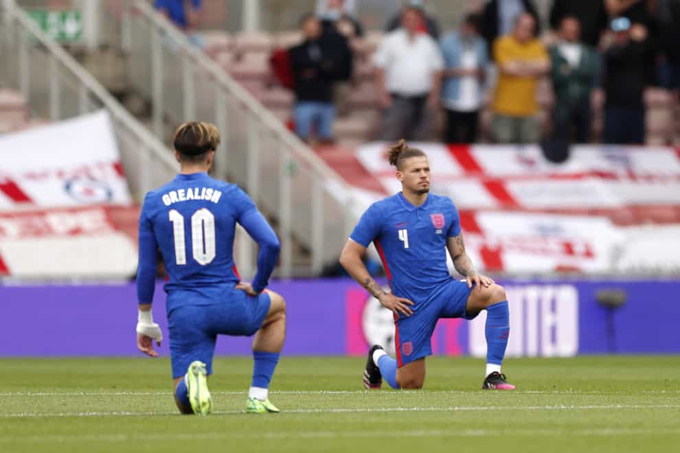England’s Jack Grealish and Kalvin Phillips take a knee before the match