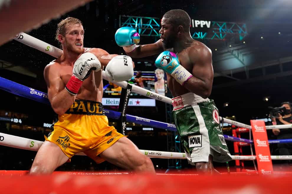Floyd Mayweather, right, throws a punch at Logan Paul, left, during an exhibition boxing match at Hard Rock Stadium in Miami Gardens, Florida