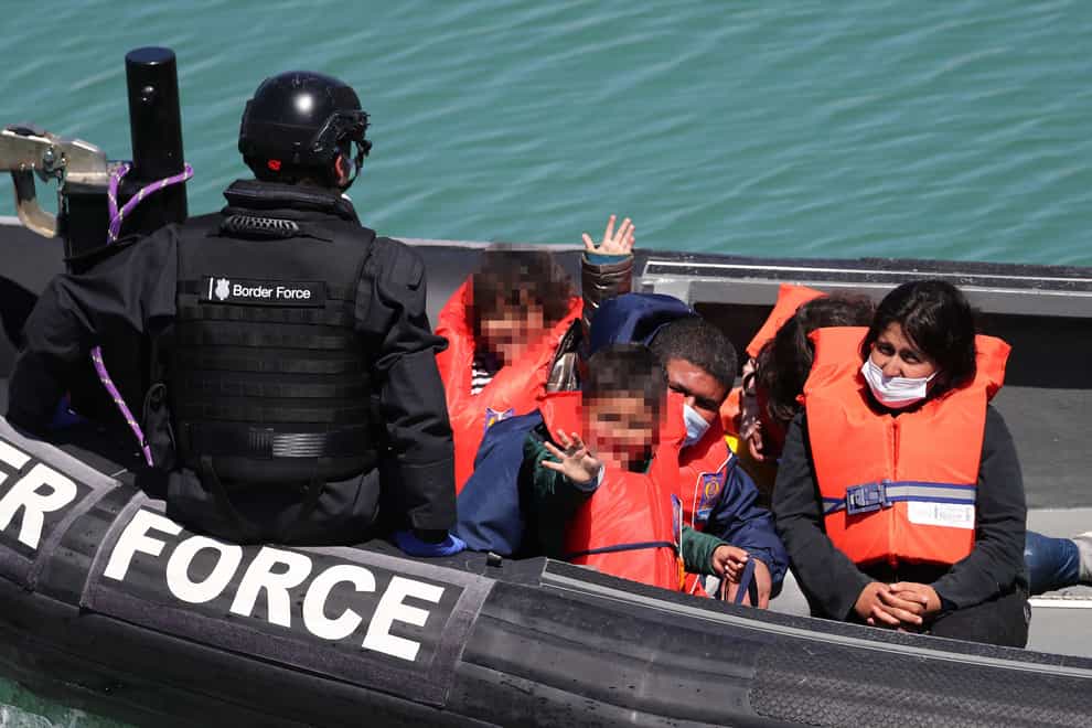 A group of people, including children, thought to be migrants are brought in to Dover