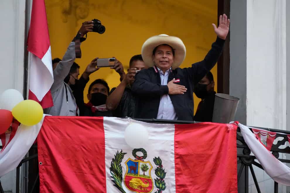 Presidential candidate Pedro Castillo waves to supporters (Martin Mejia/AP)