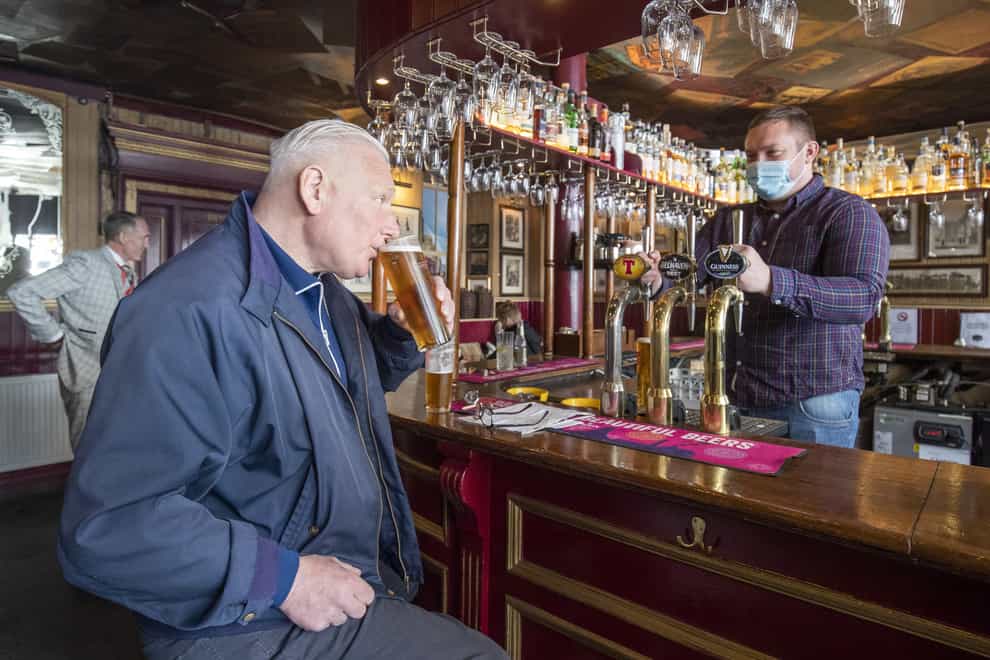 A man drinking in a pub