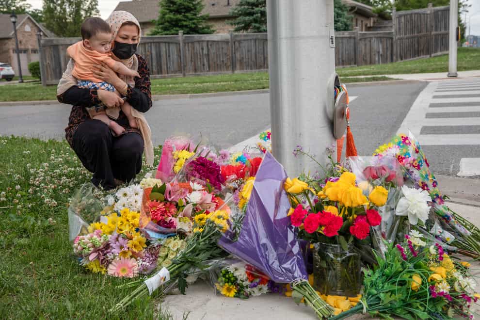 Nafisa Azima and her daughter Seena Safdari attend a memorial at the location where a family of five was hit by a driver, in London, Ontario (Brett Gundlock/AP)