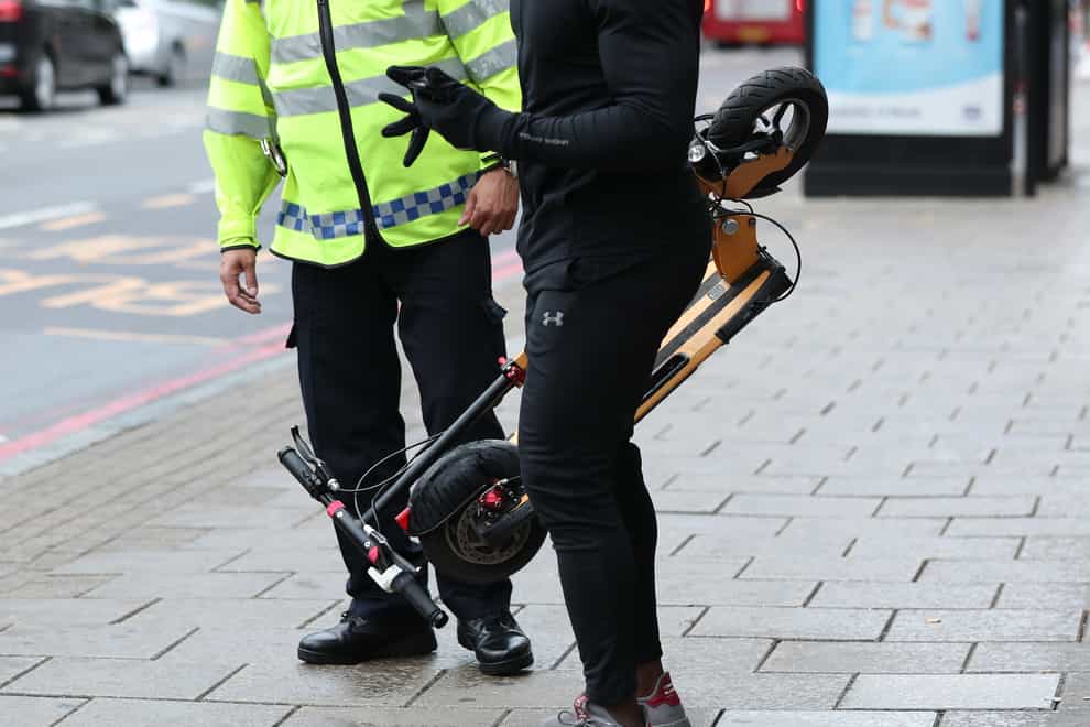 A police officer speaks to an e-scooter rider