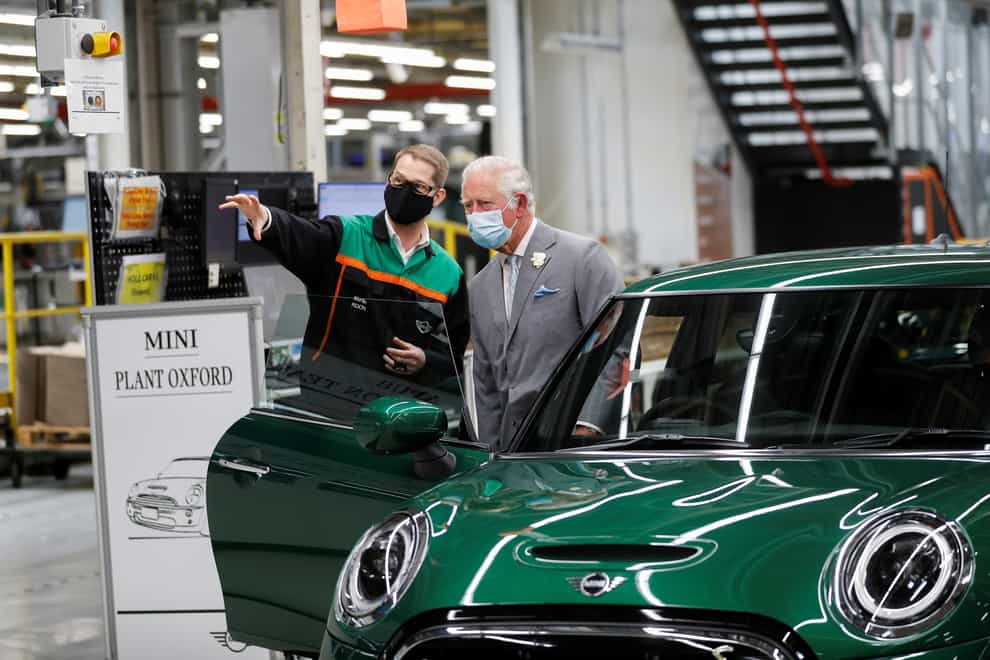 The Prince of Wales speaks to an employee during a visit to the Mini plant in Oxford (Peter Nicholls/PA)