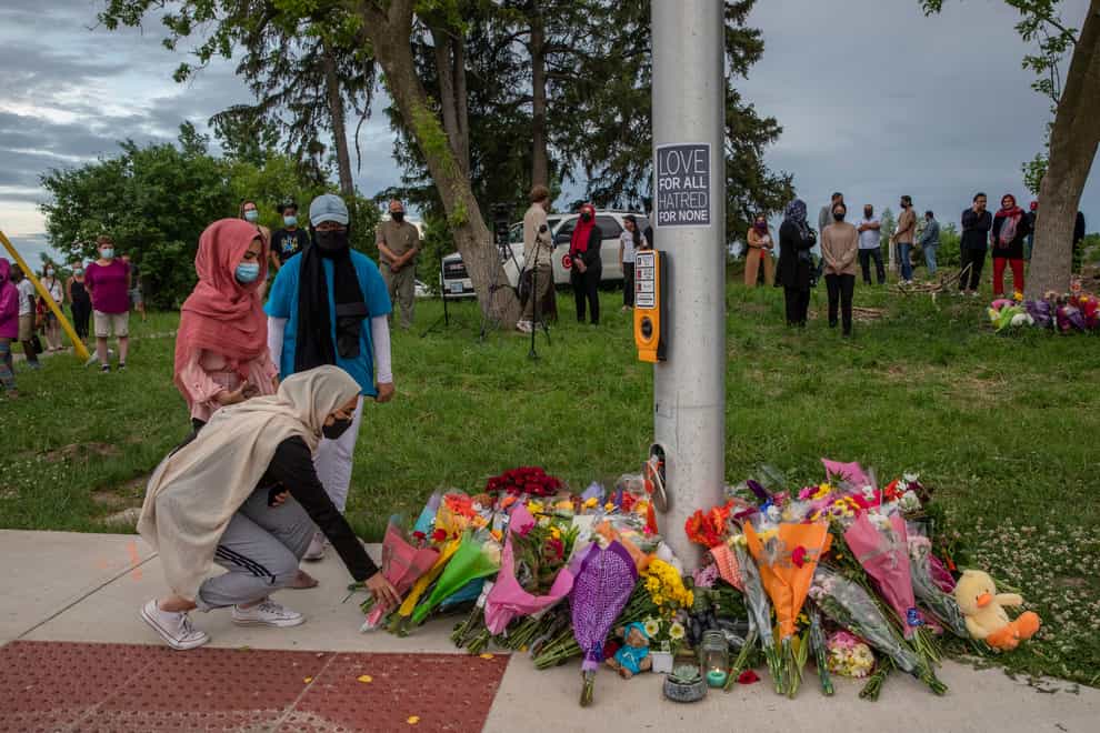 Mourners leave flowers at the site of the attack (Brett Gundlock/AP)