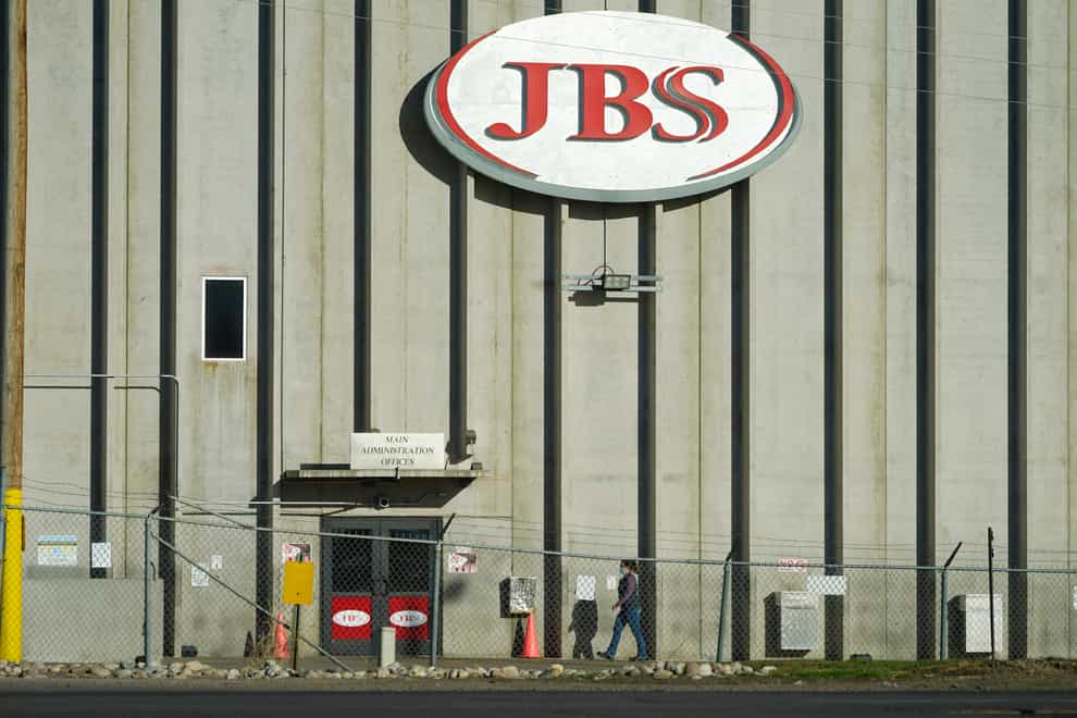 A worker heads into the JBS meatpacking plant in Greeley, Colorado