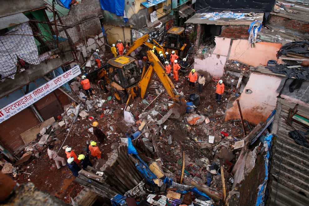 Rescuers clear debris after a building collapsed in Mumbai