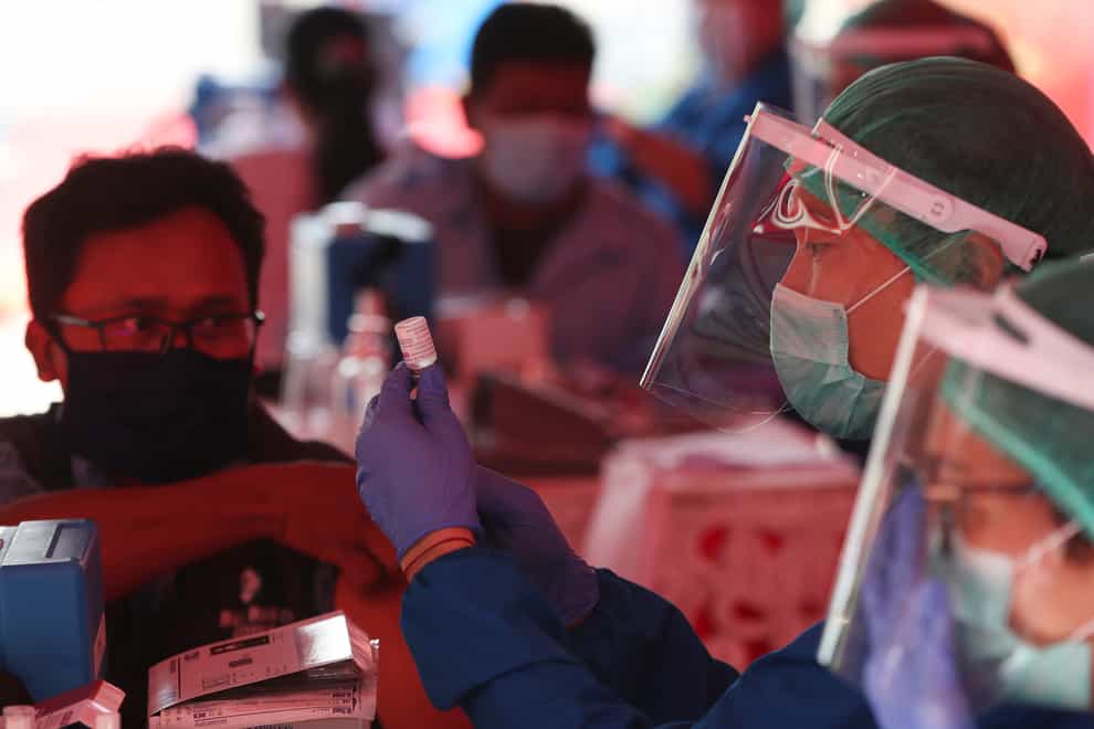 Health workers prepare doses of the AstraZeneca vaccine in Jakarta