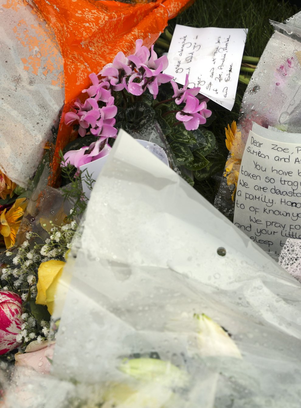 Floral tributes for Mrs Powell and her three children (Steve Parsons/PA)