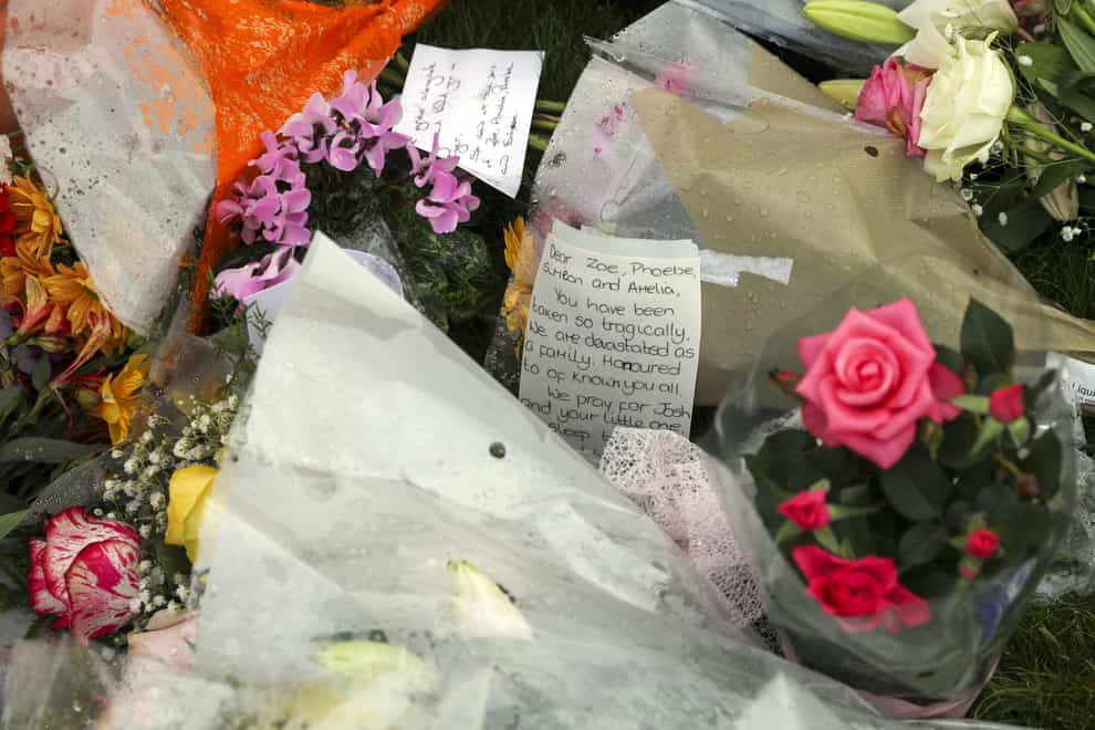 Floral tributes for Mrs Powell and her three children (Steve Parsons/PA)