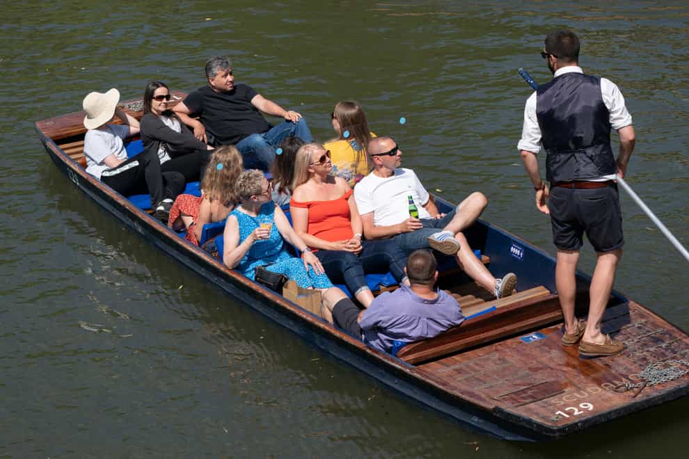 People enjoy punt tours along the River Cam in Cambridge