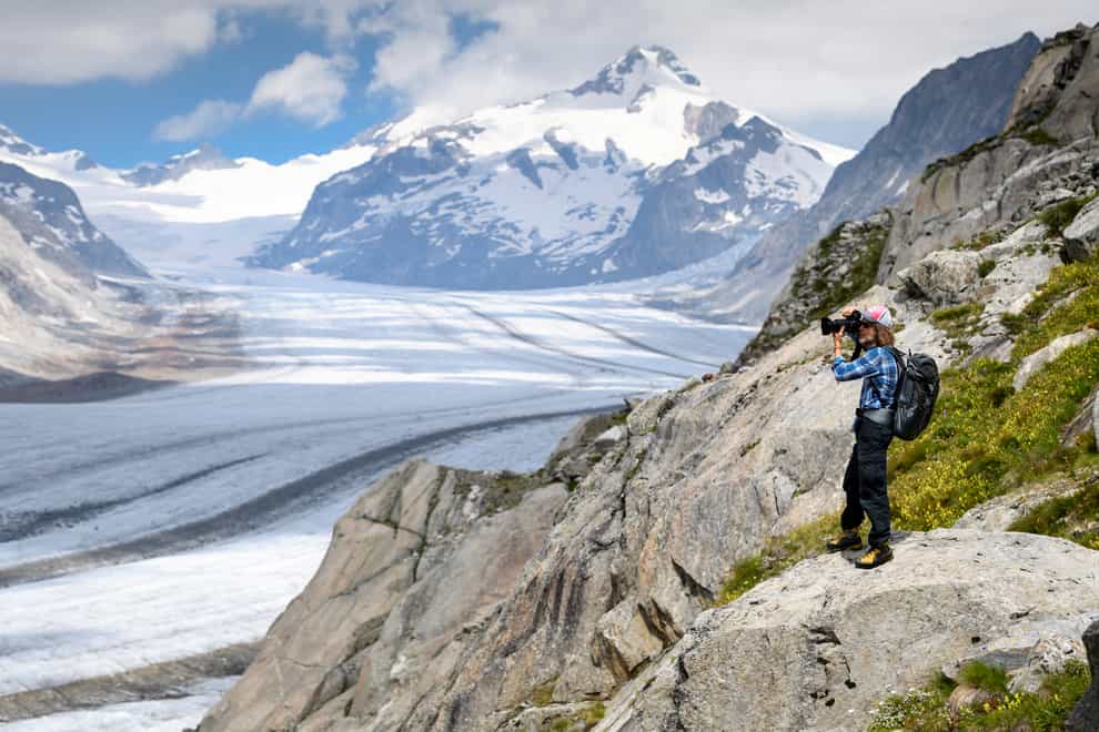 Photographer David Carlier takes pictures of the Swiss Aletsch glacier, the longest glacier in Europe, in Fieschertal