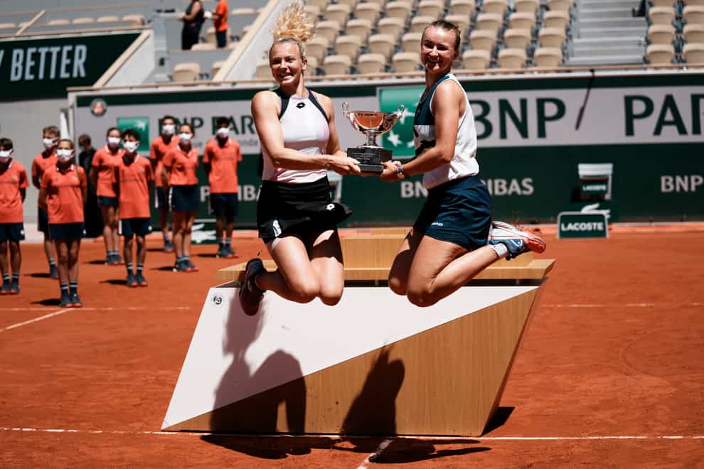 Barbora Krejcikova, right, and Katerina Siniakova do a celebratory leap
