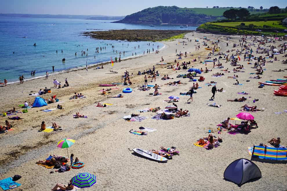 People enjoy the sunshine on Gyllyngvase Beach near Falmouth in Cornwall
