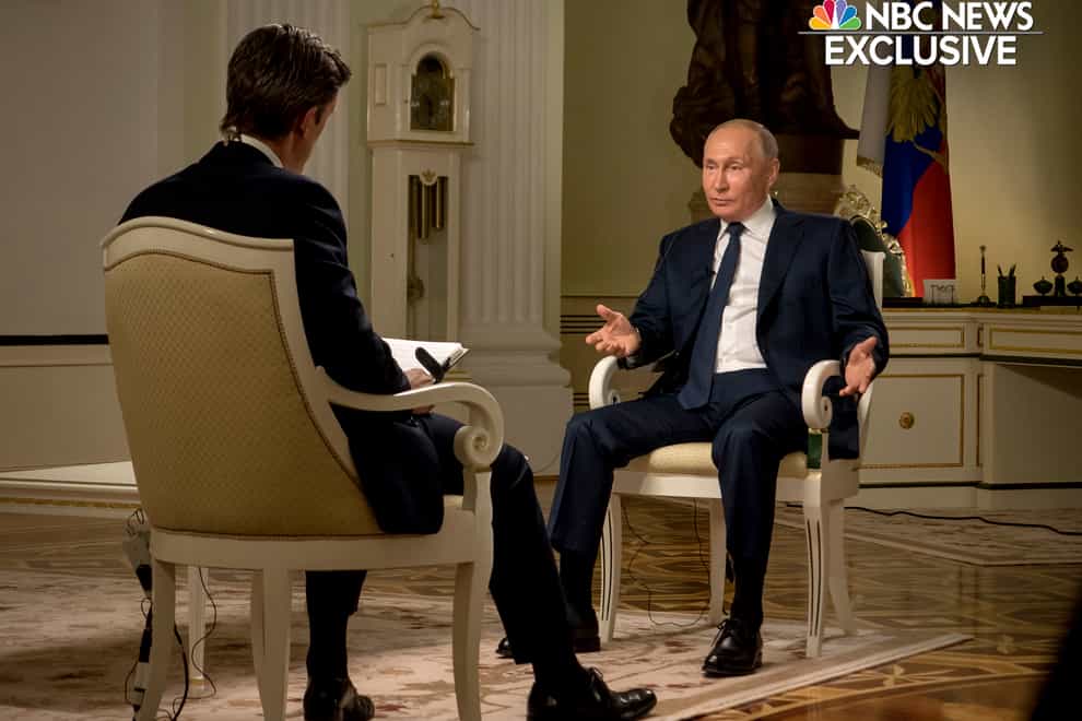 NBC News journalist Keir Simmons, left, speaks with Russian President Vladimir Putin
