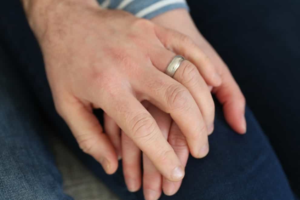 <p>A married couple hold hands.</p>