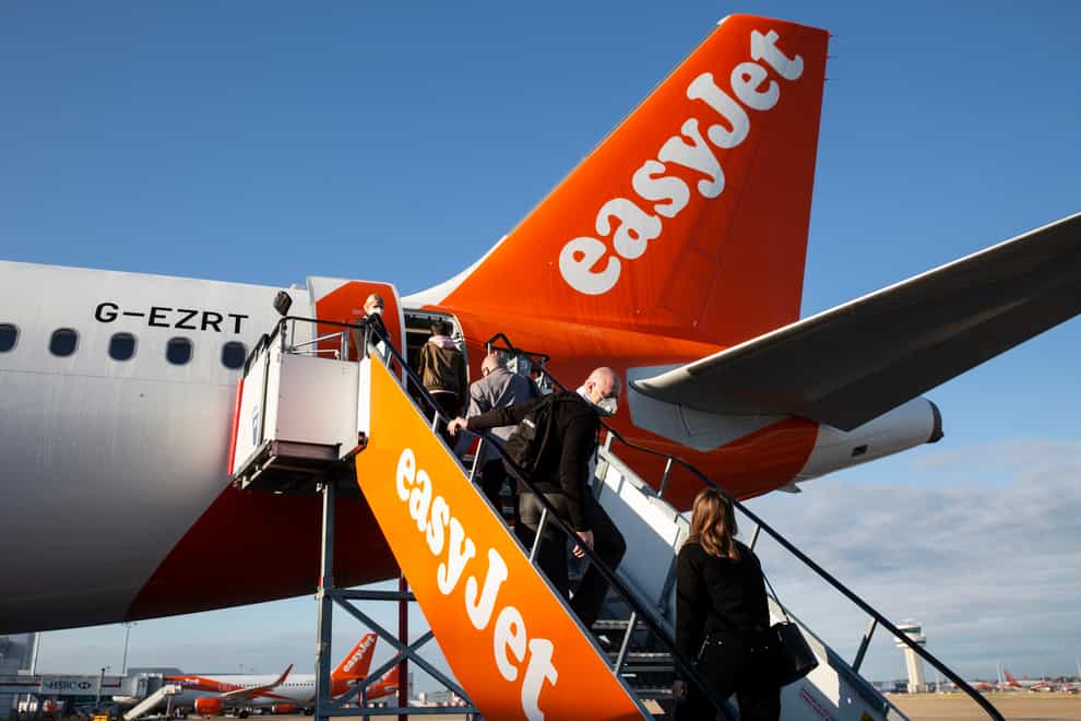 Passengers board an easyJet plane