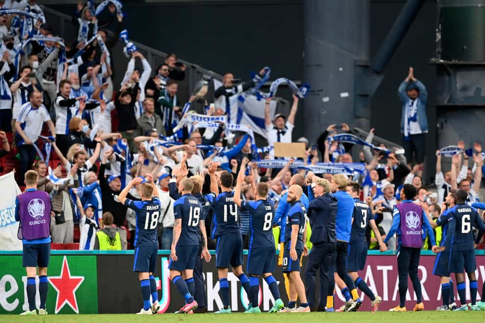 Finland players celebrate with their fans after beating Denmark in their opening group match