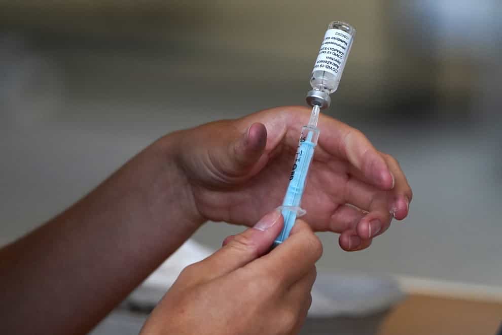 A vial of vaccine is held at the vaccination centre at Ravenscraig Regional Sports Facility in Motherwell