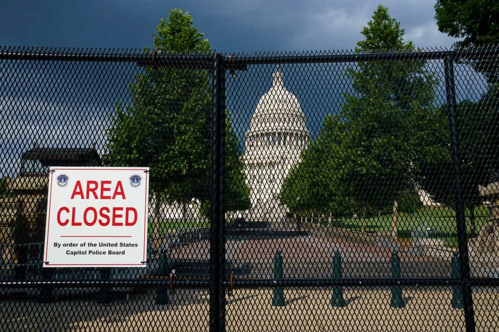 The US Capitol behind perimeter fencing