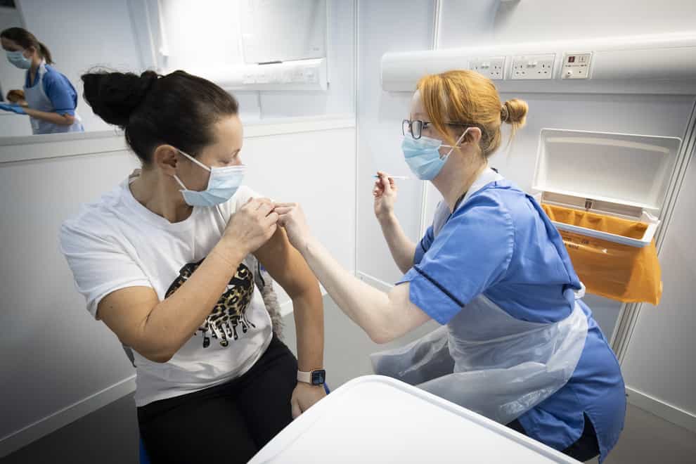 A woman receives a Covid jab from a nurse