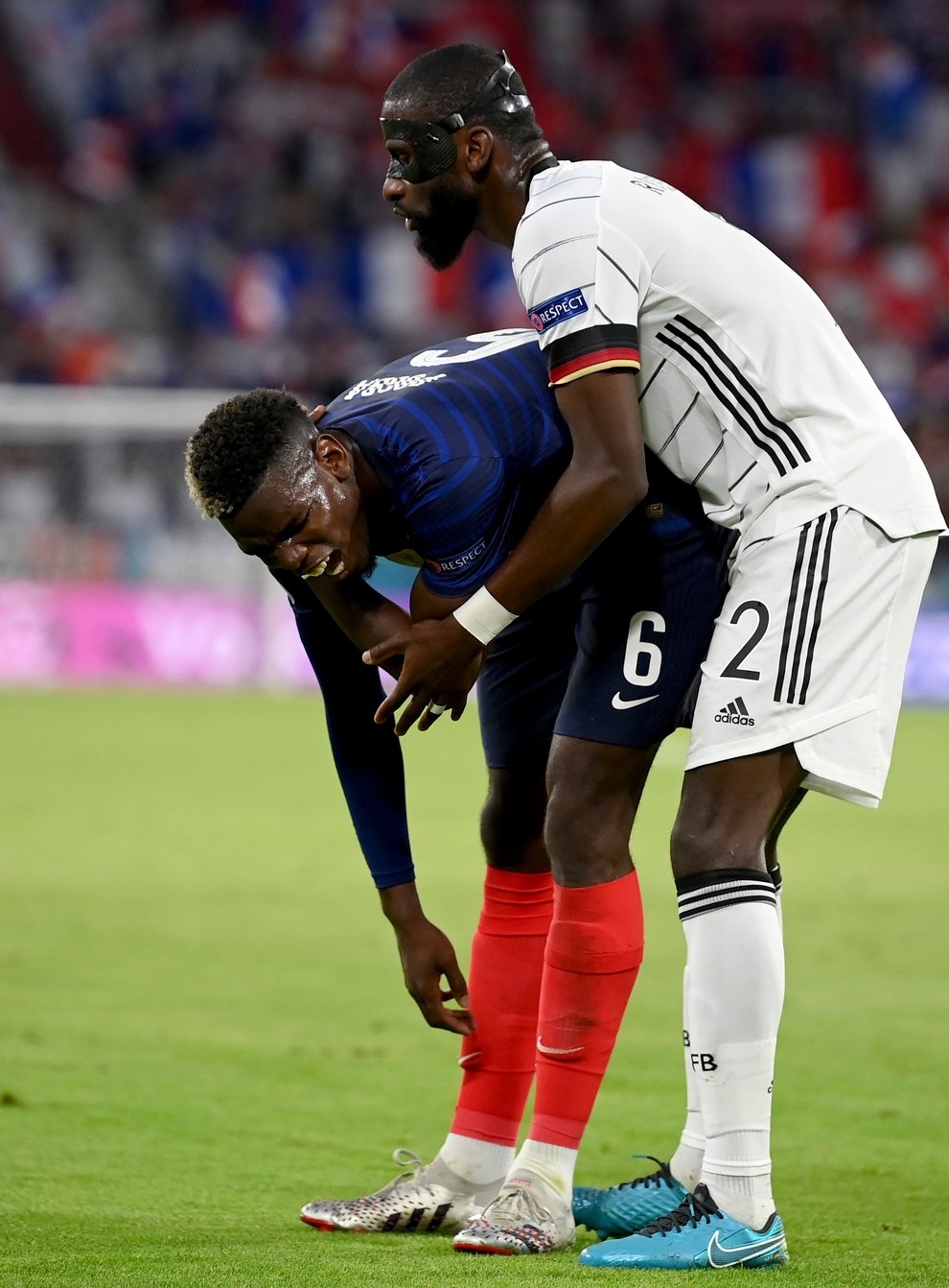 Antonio Rudiger, right, stands beside France’s Paul Pogba