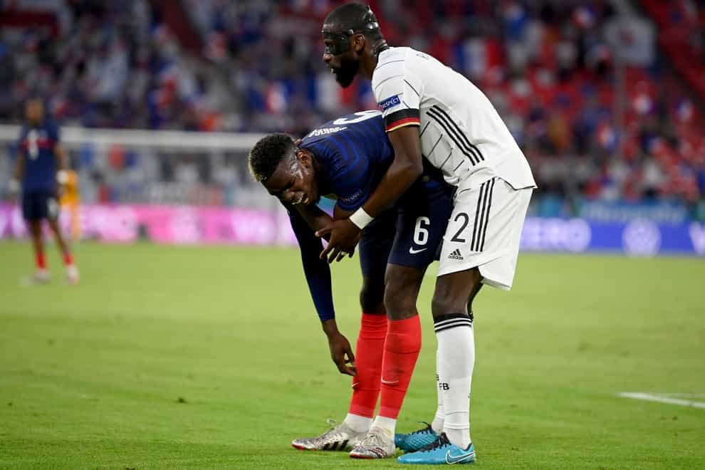 Antonio Rudiger, right, stands beside France’s Paul Pogba