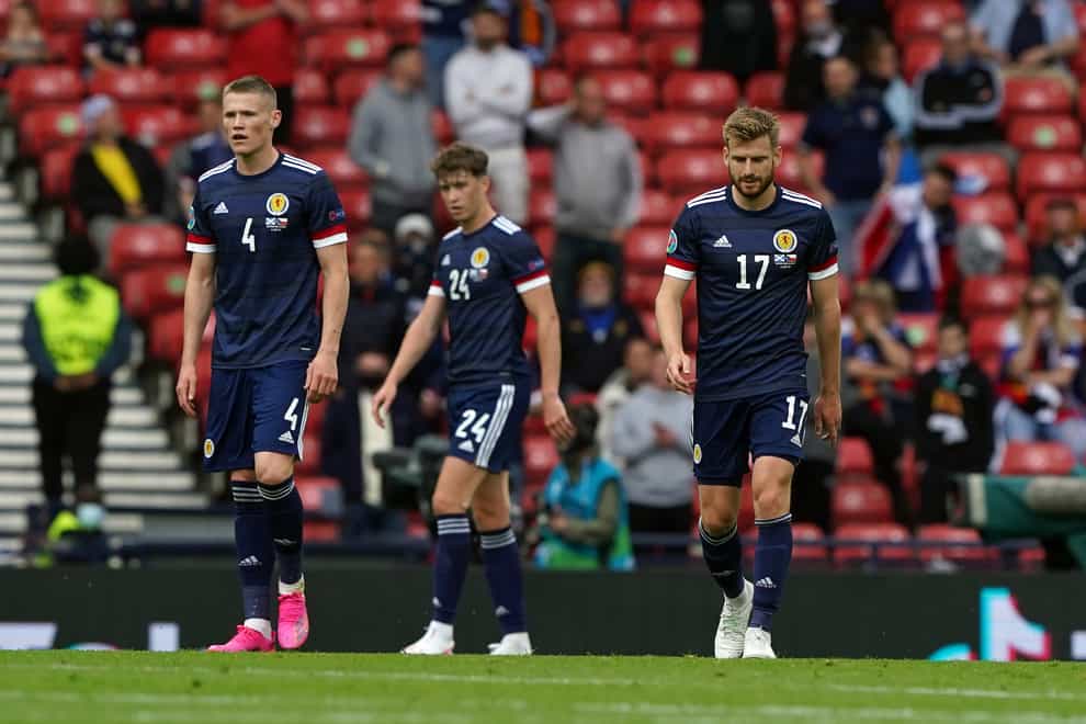 Scotland’s Scott McTominay, Jack Hendry and Stuart Armstrong stand dejected at Hampden Park