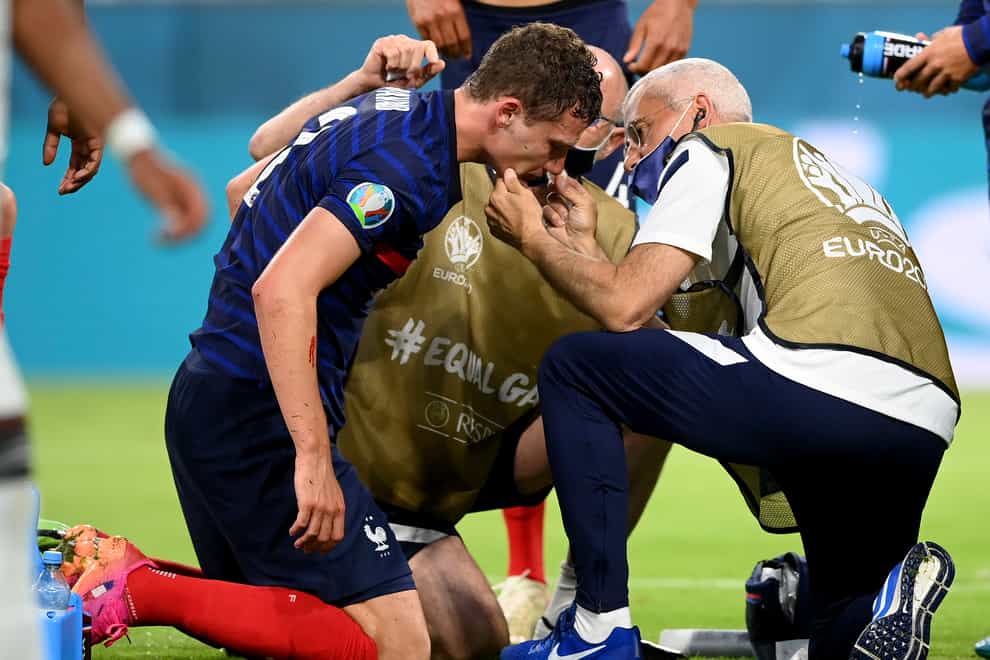 Benjamin Pavard receives treatment after his collision with Germany's Robin Gosens on Tuesday night