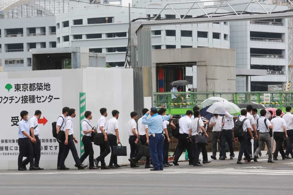 Police officers and firefighters arrive to receive their coronavirus vaccine in Tokyo