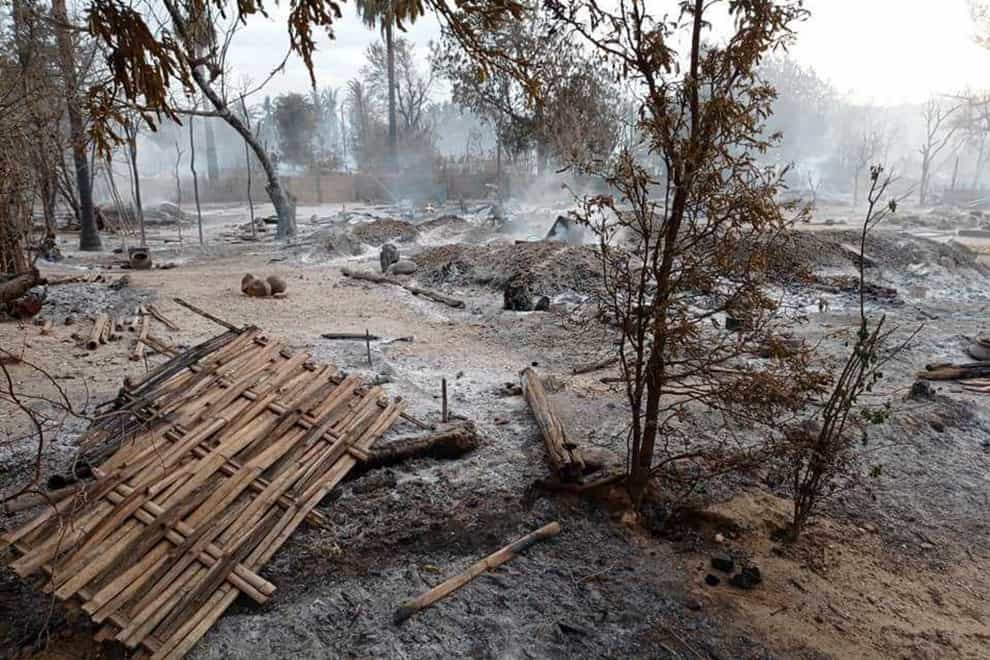 Smoke rises from smouldering houses in Kinma village in central Myanmar